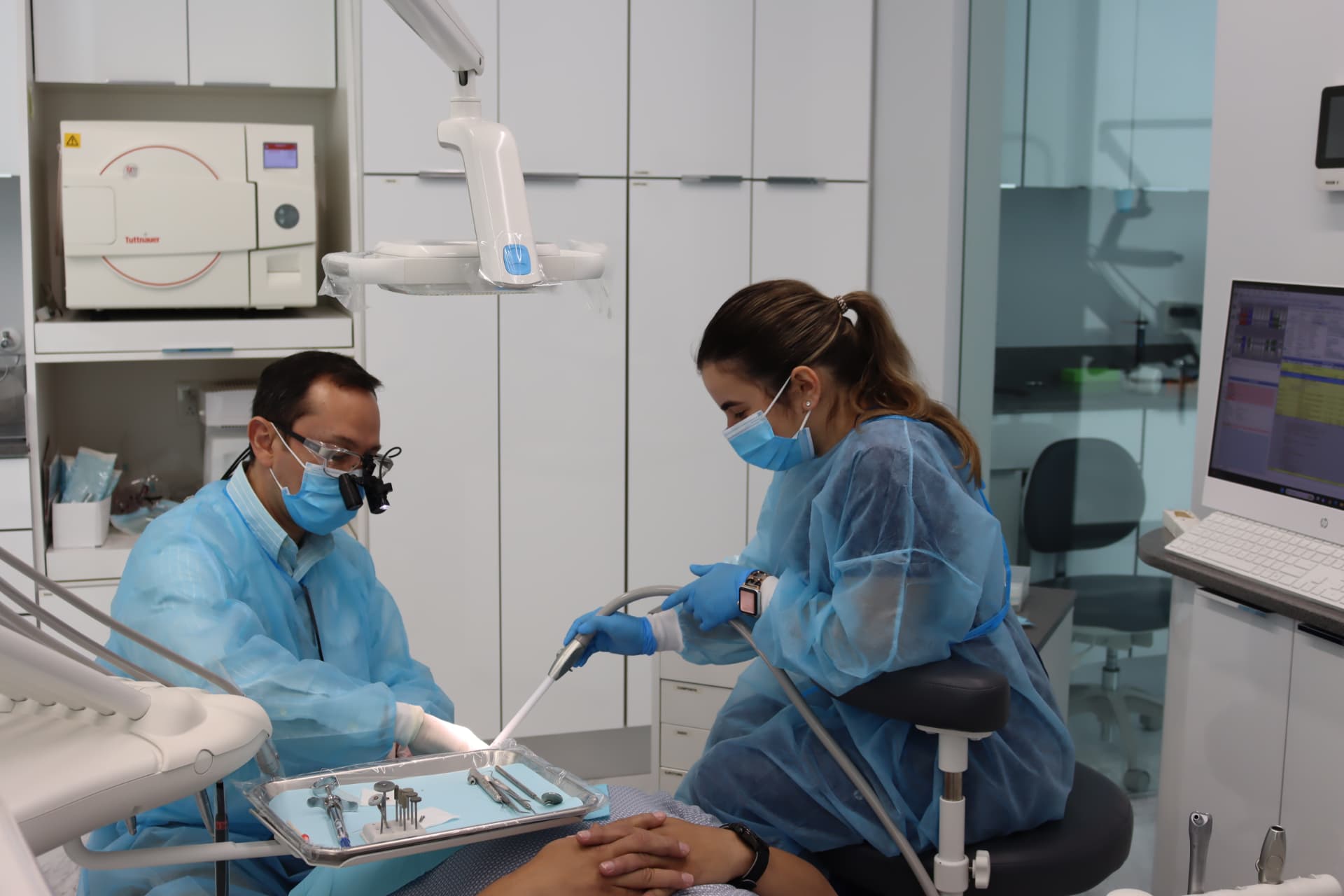 Dr. Dongo and a dental assistant working together during patient care