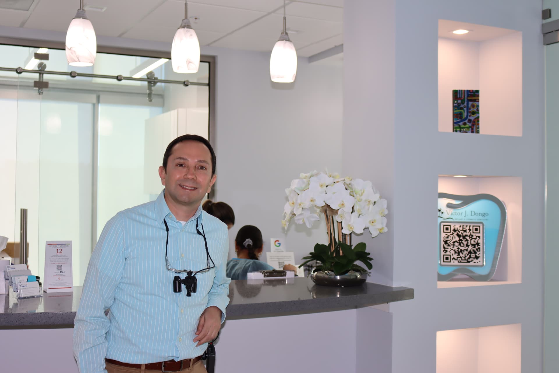 Dr. Victor Dongo welcoming patients at the Beacon Dental reception area