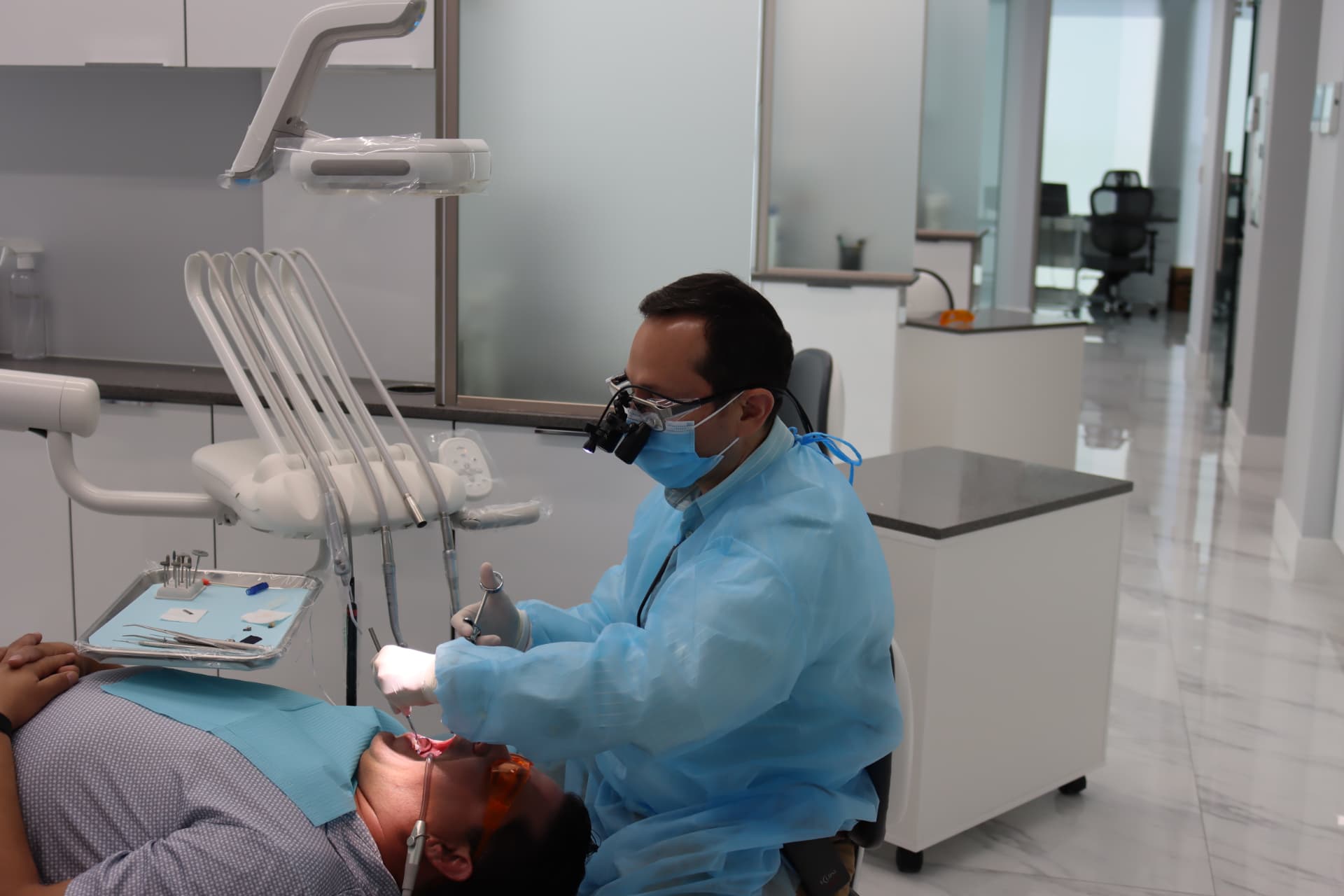 Dr. Victor Dongo providing attentive dental care in a modern treatment room