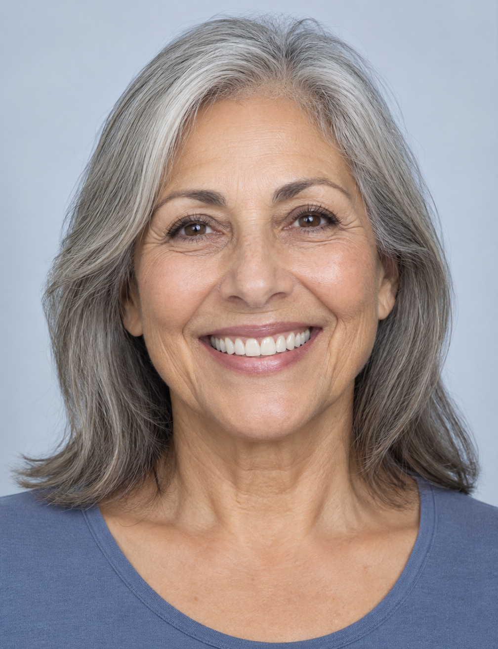 Older woman after restorative cosmetic treatment with a complete, naturally bright smile